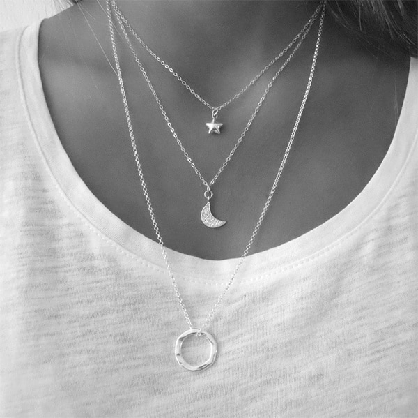Woman wearing three necklaces