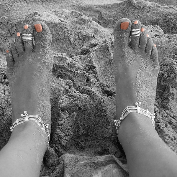 Woman wearing toe rings on beach